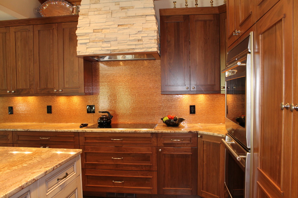 Inspiration for a huge transitional l-shaped slate floor open concept kitchen remodel in Denver with an undermount sink, flat-panel cabinets, dark wood cabinets, granite countertops, brown backsplash, glass tile backsplash, stainless steel appliances and an island