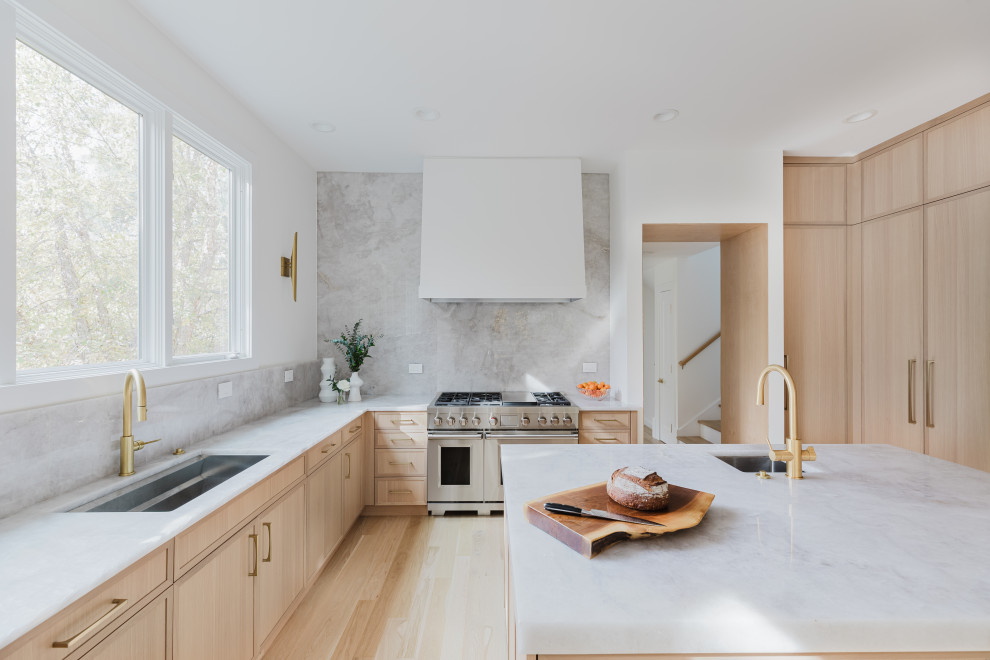 Modern Bright Kitchen With Marble Island and Large Windows Overlooking Greenery