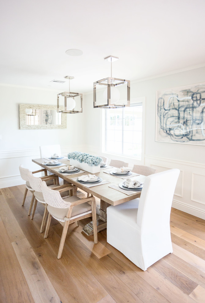 Inspiration for a mid-sized transitional separate dining room in Phoenix with blue walls, light hardwood floors, no fireplace and brown floor.