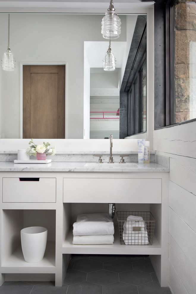 Modern Ski Home - Example of a mountain style gray floor bathroom design with flat-panel cabinets, white cabinets, white countertops, white walls and a built-in vanity