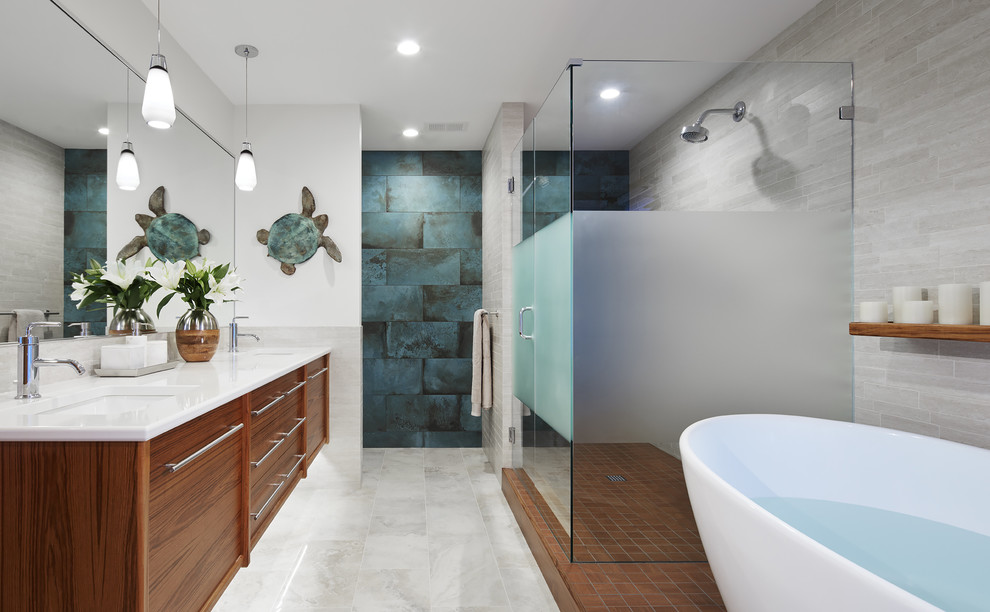 Inspiration for a contemporary master ceramic tile and turquoise tile marble floor and gray floor freestanding bathtub remodel in Minneapolis with medium tone wood cabinets, white walls, an undermount sink, a two-piece toilet, marble countertops, a hinged shower door and flat-panel cabinets