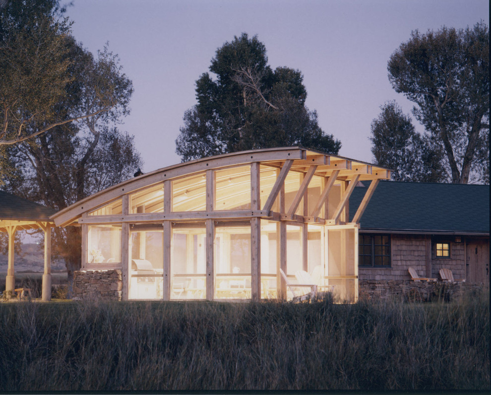 Mid-sized rustic one-story wood exterior home idea with a shed roof