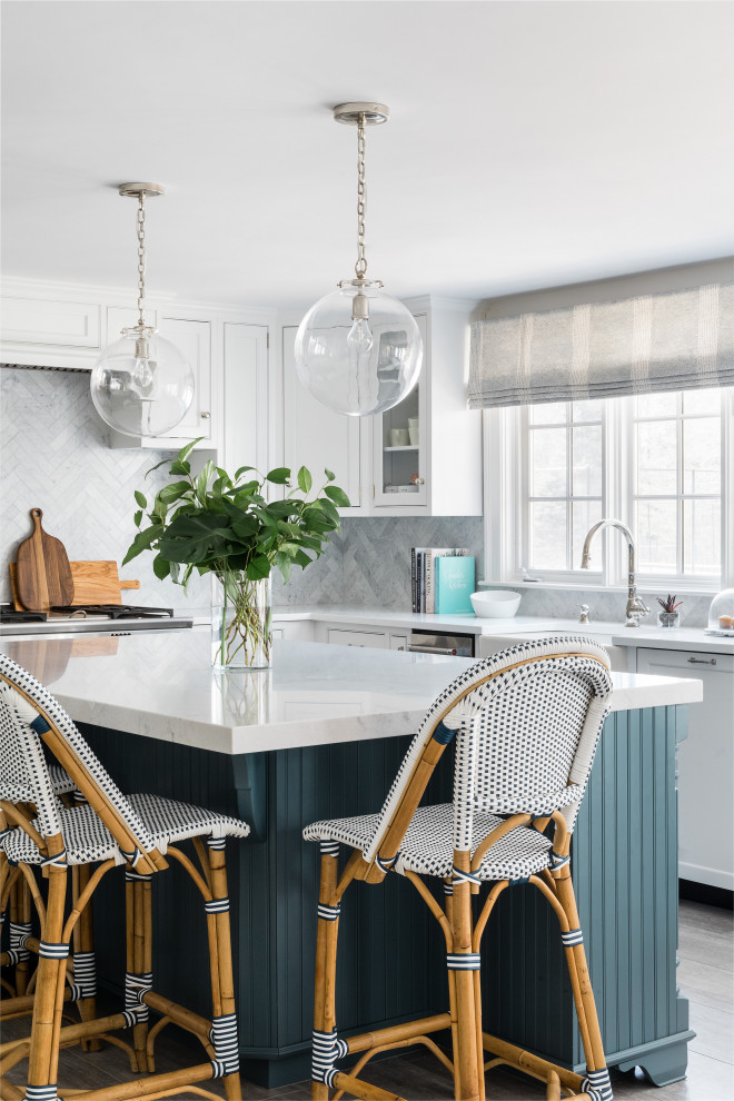 Example of a beach style kitchen design in Boston with an island
