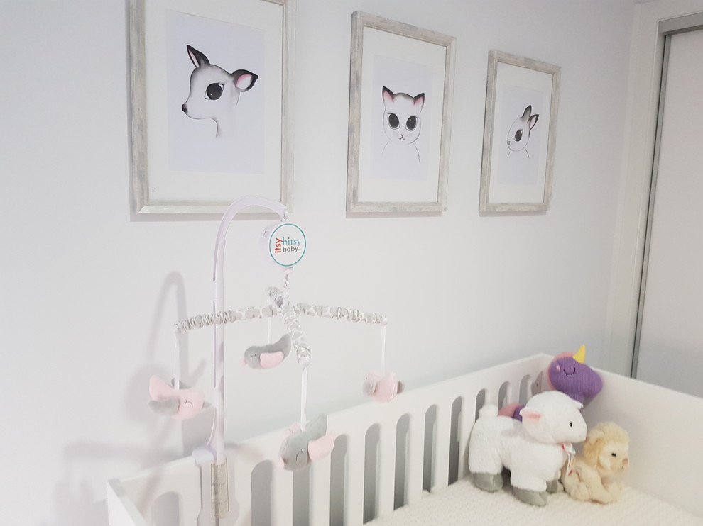 Mid-sized contemporary gender-neutral nursery in Melbourne with white walls and carpet.