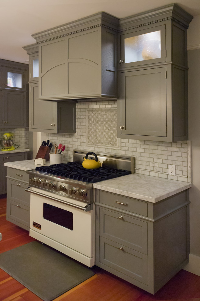 This is an example of a mid-sized traditional u-shaped separate kitchen in San Francisco with a farmhouse sink, shaker cabinets, grey cabinets, marble benchtops, white splashback, stone tile splashback, white appliances, medium hardwood floors and with island.
