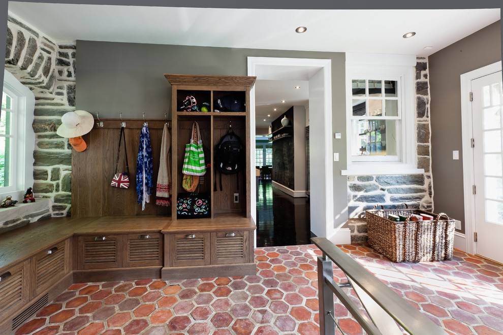 Contemporary mudroom in Philadelphia with grey walls and terra-cotta floors.