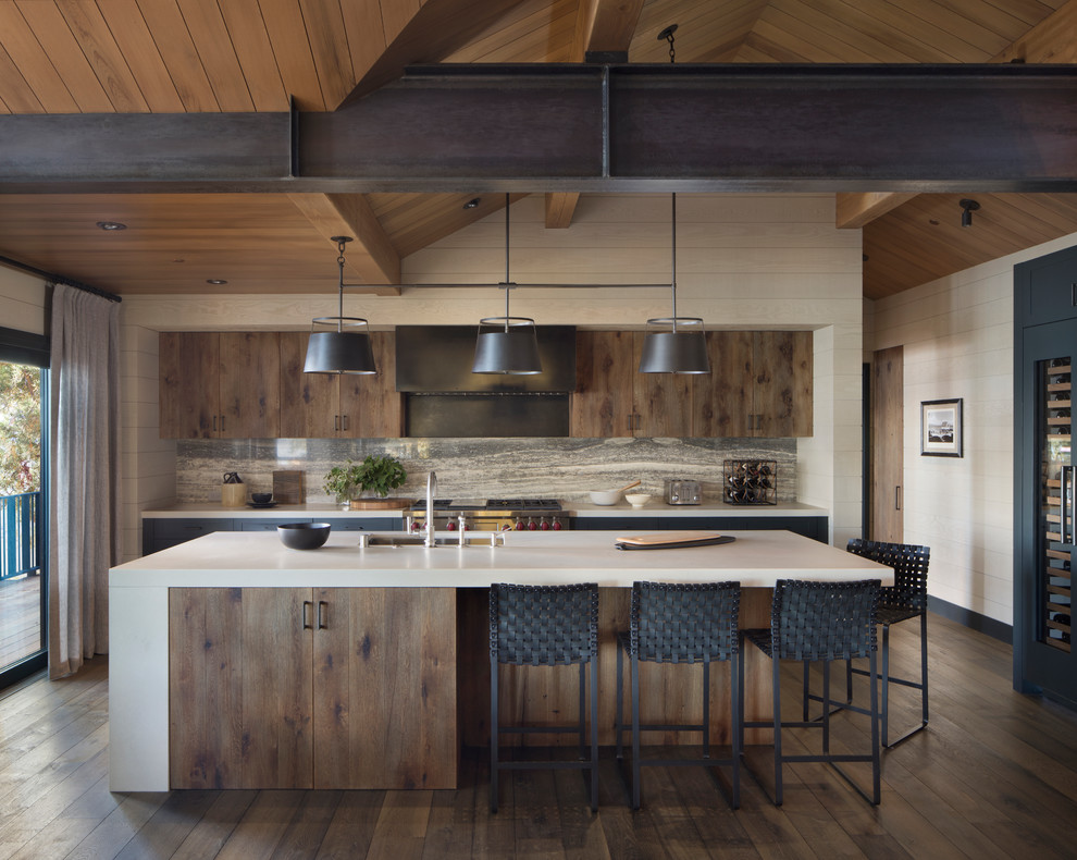 Country l-shaped kitchen in San Francisco with an undermount sink, flat-panel cabinets, medium wood cabinets, grey splashback, stone slab splashback, stainless steel appliances, dark hardwood floors, with island, brown floor and beige benchtop.