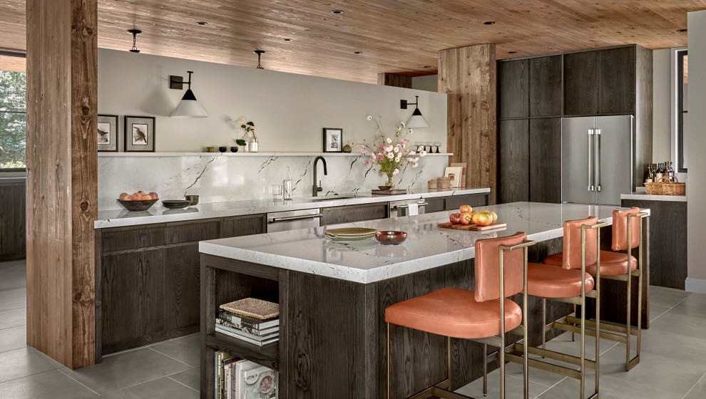 Inspiration for a large country single-wall porcelain tile, gray floor and wood ceiling open concept kitchen remodel in Other with an undermount sink, flat-panel cabinets, dark wood cabinets, quartz countertops, white backsplash, quartz backsplash, stainless steel appliances, an island and white countertops
