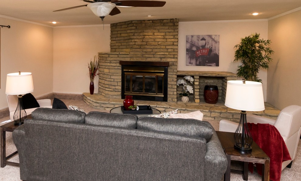 This is an example of a large traditional open concept living room in Cincinnati with beige walls, carpet, a standard fireplace, a stone fireplace surround, beige floor and no tv.