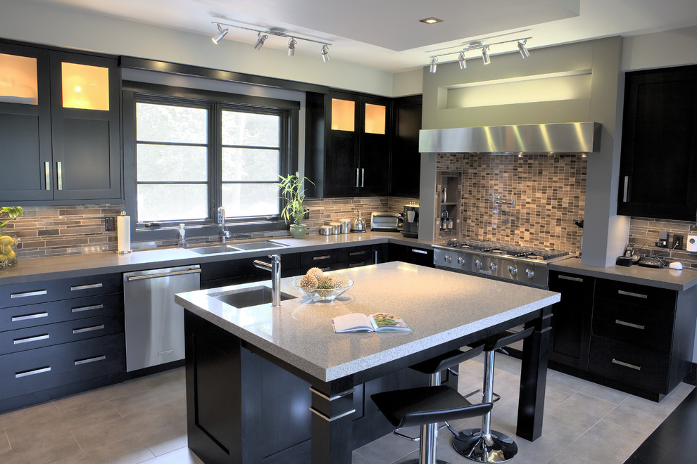 Contemporary kitchen in Wilmington with a double-bowl sink, flat-panel cabinets, black cabinets, multi-coloured splashback, matchstick tile splashback and stainless steel appliances.