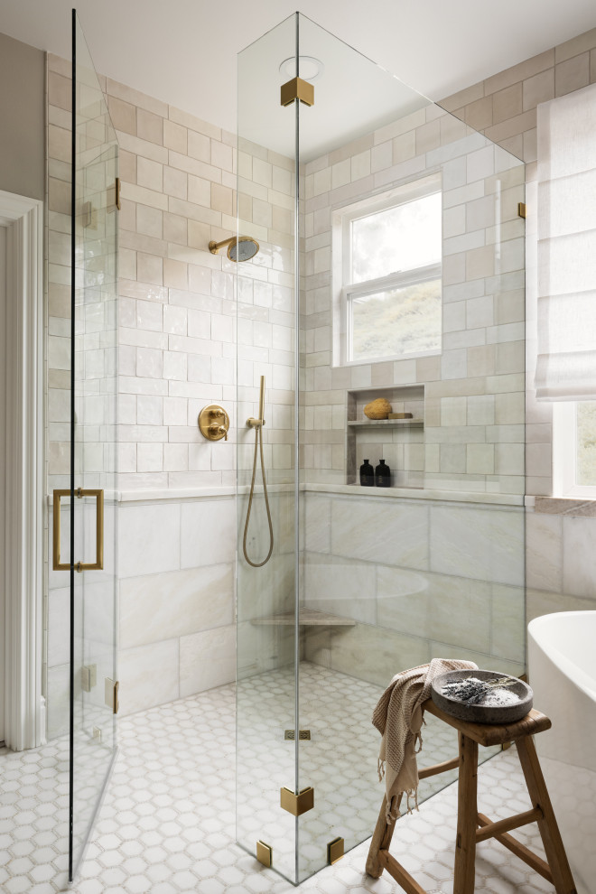 Inspiration for a mid-sized transitional master beige tile and ceramic tile marble floor, multicolored floor and double-sink freestanding bathtub remodel in Orange County with shaker cabinets, beige cabinets, a two-piece toilet, beige walls, an undermount sink, quartzite countertops, a hinged shower door, beige countertops, a niche and a built-in vanity