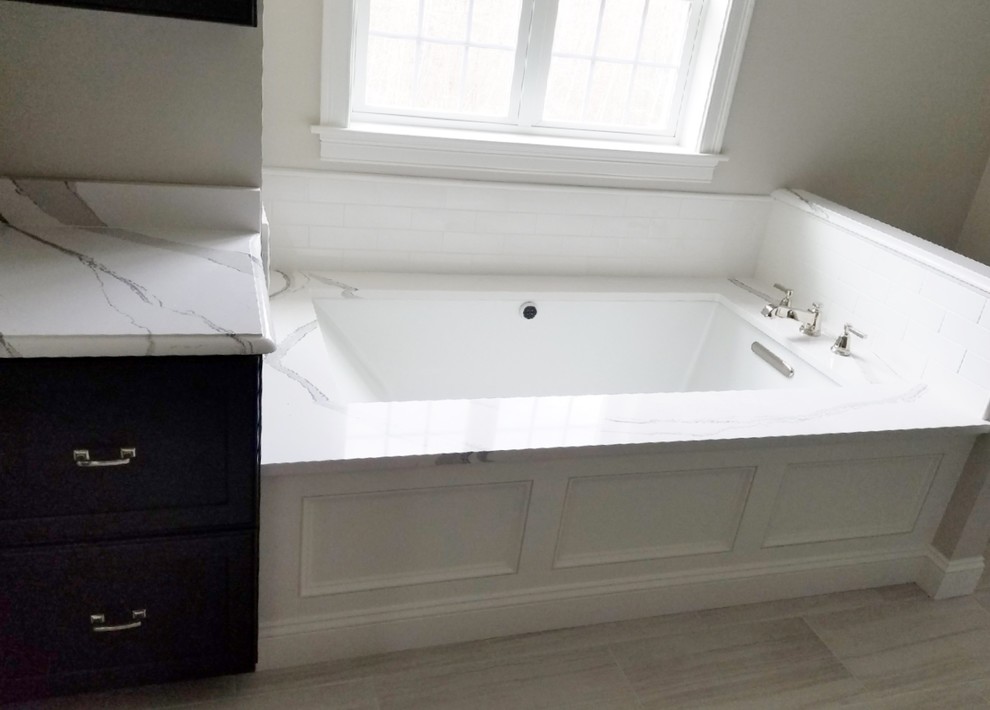 Bathroom - large transitional master porcelain tile and beige floor bathroom idea in Boston with dark wood cabinets and an undermount tub
