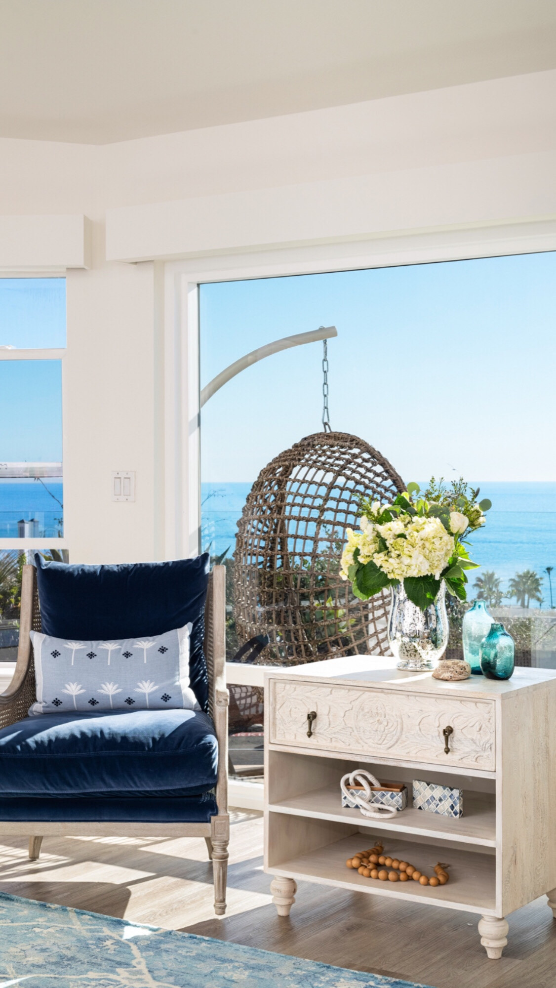 Sitting area to relax and read in a beautiful cane chair with blue velvet