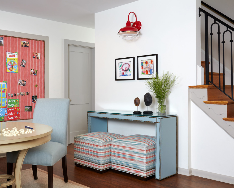 #mcleanrenovation - Rec Room with Game Table and Bulletin Board - Bright and cheerful basement rec room with beige sectional, game table, built-in storage, and aqua and red accents.

Photo by Stacy Zarin Goldberg Photography