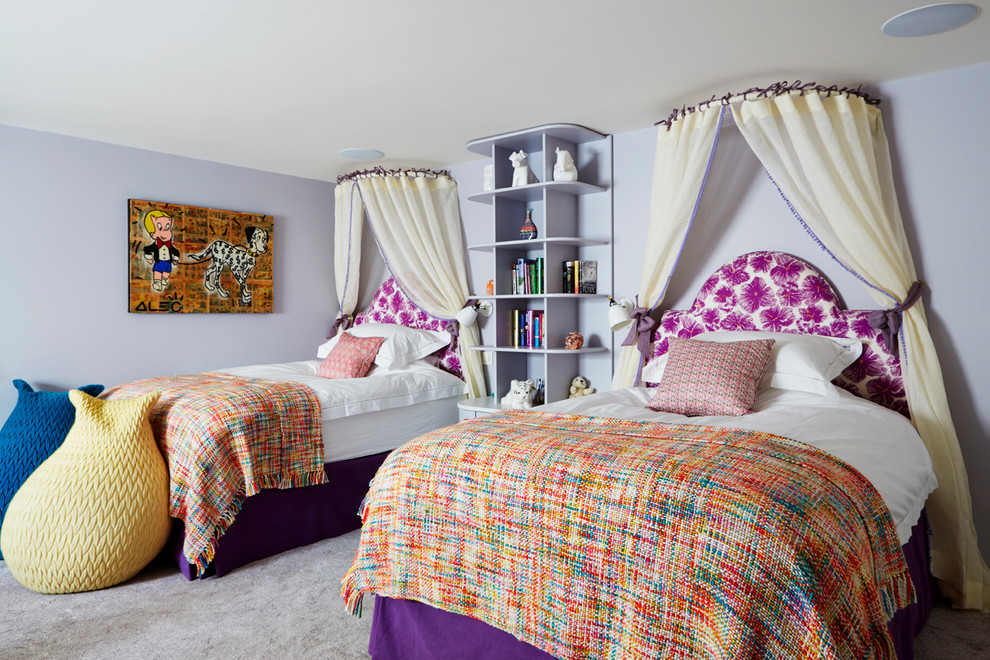 Photo of a large contemporary kids' bedroom for girls and kids 4-10 years old in London with purple walls and carpet.