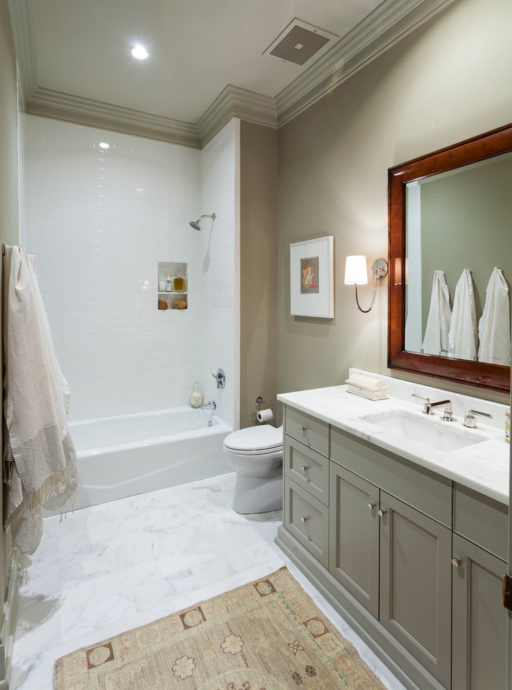Inspiration for a traditional bathroom in Charlotte with an undermount sink, an alcove tub, a shower/bathtub combo, white tile and beige walls.