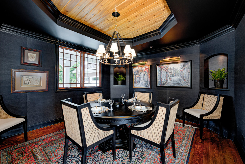 This is an example of a medium sized eclectic enclosed dining room in Indianapolis with medium hardwood flooring, a timber clad ceiling and black walls.