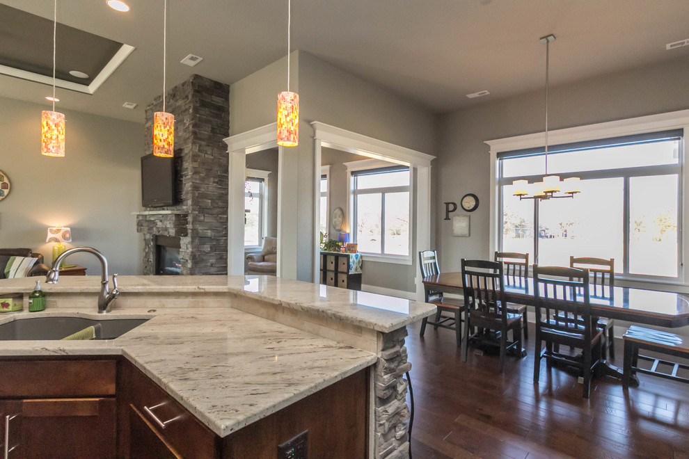 Mid-sized transitional medium tone wood floor kitchen/dining room combo photo with gray walls and no fireplace