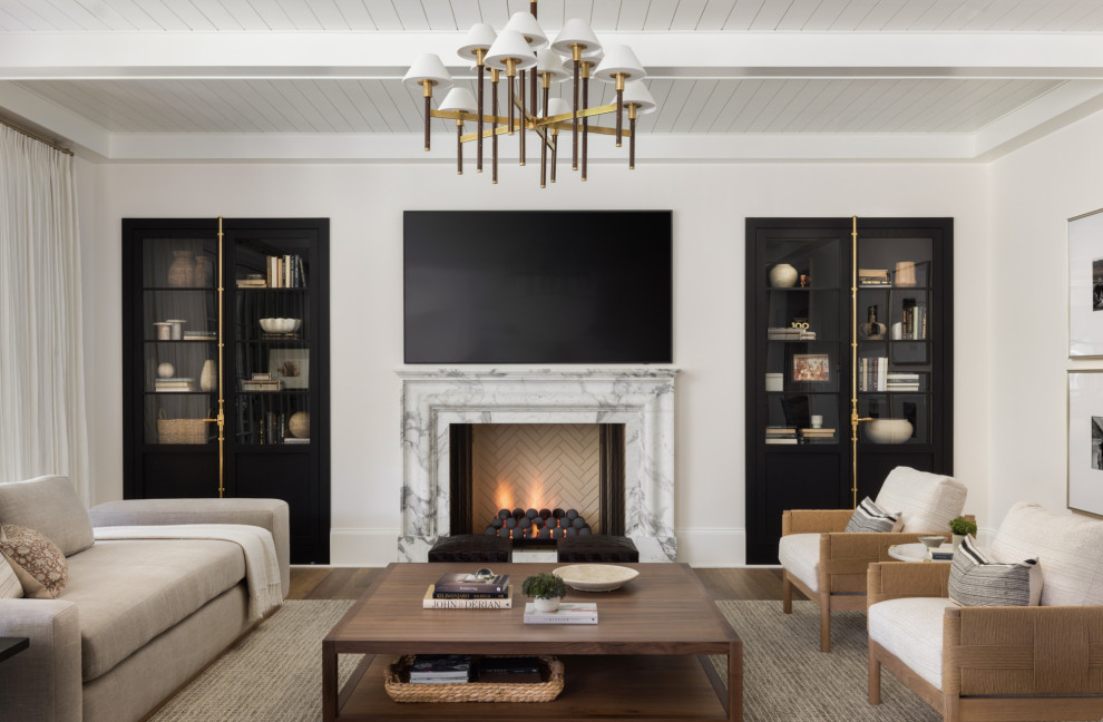 Inspiration for a large transitional open concept living room in DC Metro with white walls, medium hardwood floors, a standard fireplace, a stone fireplace surround, a wall-mounted tv, brown floor and timber.