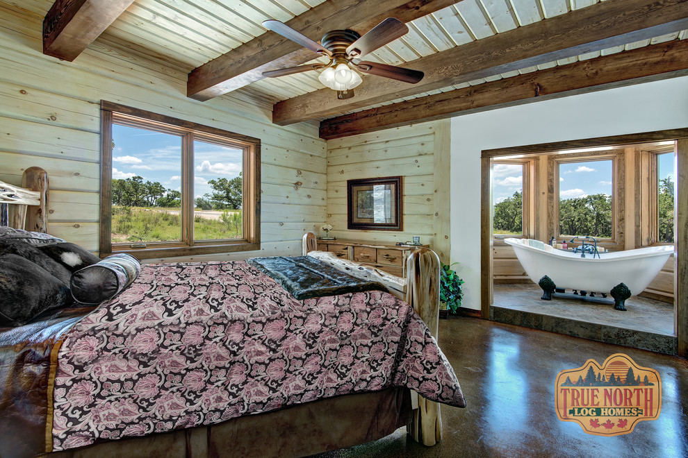 Country master bedroom in Austin with brown walls and brown floor.