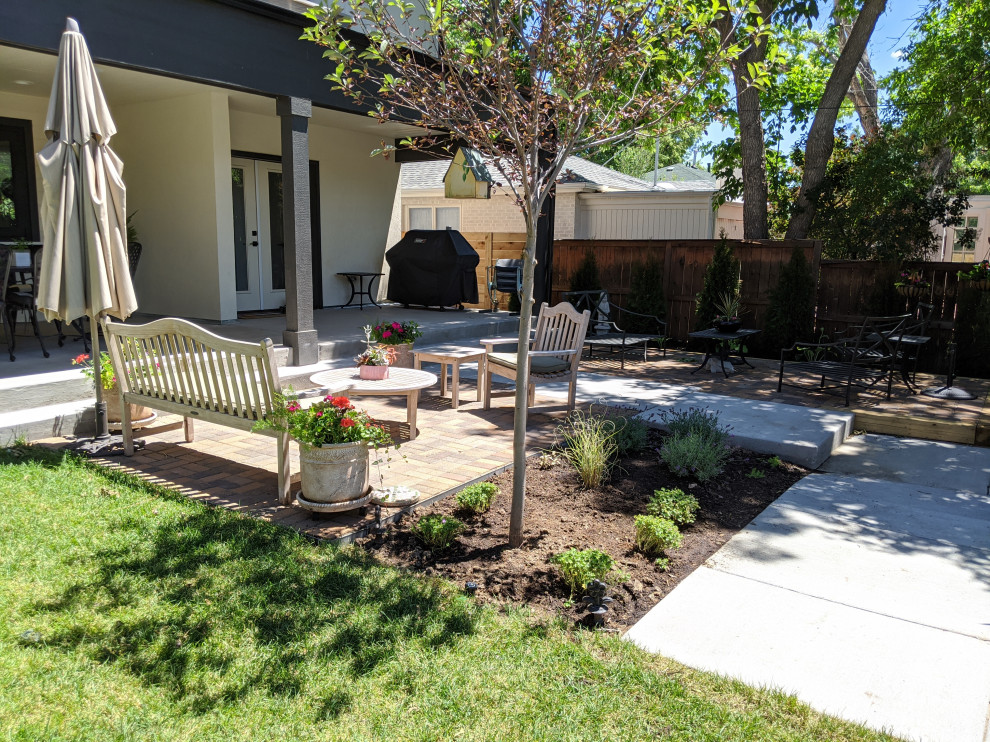 Design ideas for a mid-sized country backyard full sun garden in Denver with a container garden and brick pavers.