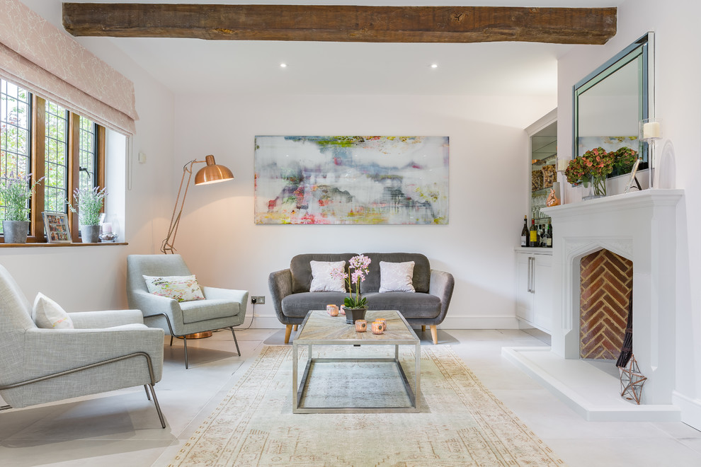Inspiration for a mid-sized transitional living room in Hertfordshire with ceramic floors, a standard fireplace, a stone fireplace surround, no tv and grey floor.