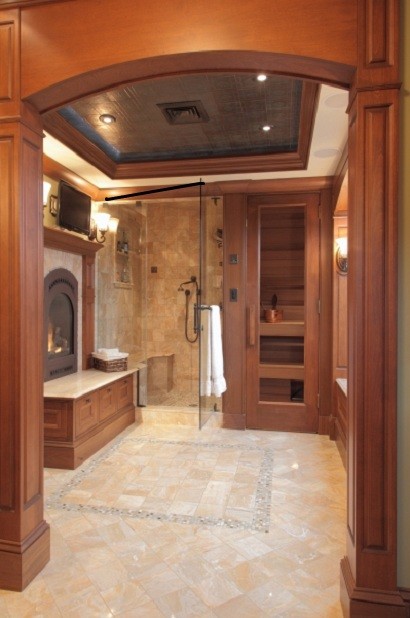Photo of a traditional bathroom in Boston with medium wood cabinets, a freestanding tub, a corner shower, beige tile, cement tile, beige walls and ceramic floors.