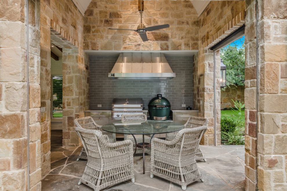 Photo of a transitional patio in Dallas with natural stone pavers and a roof extension.