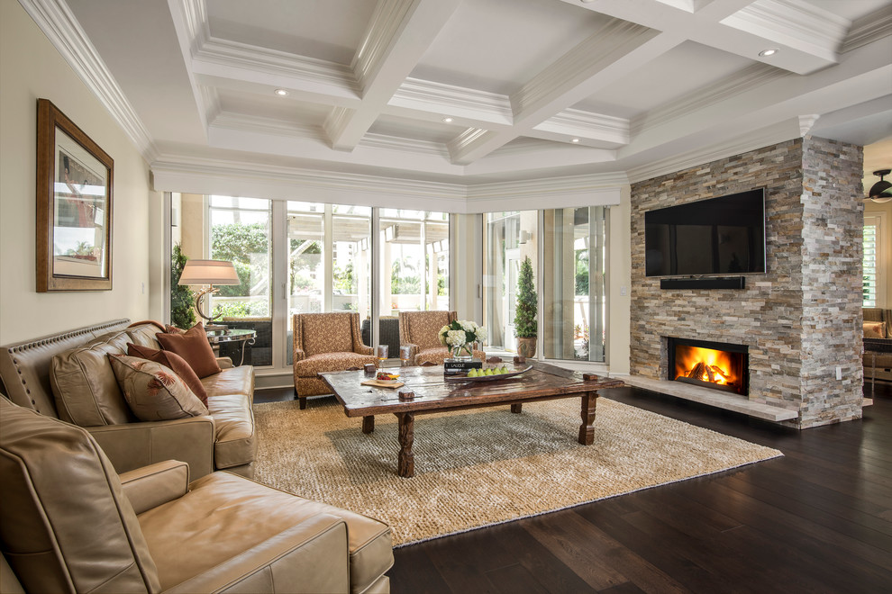 Photo of a mid-sized traditional formal enclosed living room in Miami with a stone fireplace surround, beige walls, dark hardwood floors, a standard fireplace, no tv and brown floor.