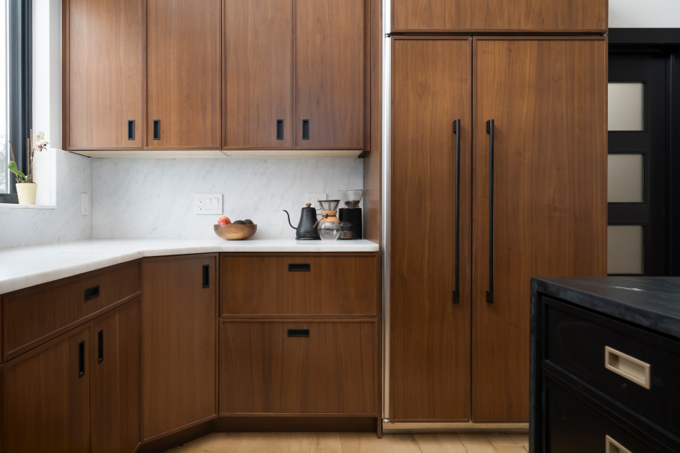 Medium sized industrial l-shaped open plan kitchen in Denver with shaker cabinets, medium wood cabinets, marble worktops, integrated appliances, light hardwood flooring, an island, brown floors and multicoloured worktops.