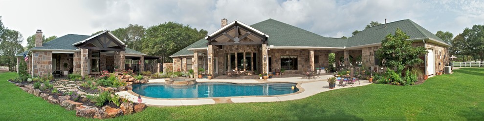 Inspiration for a large traditional one-storey beige exterior in Houston with stone veneer and a hip roof.