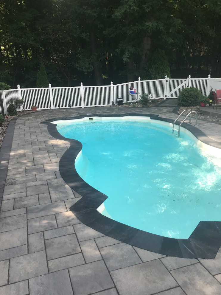 Inspiration for a mid-sized transitional concrete paver pool remodel