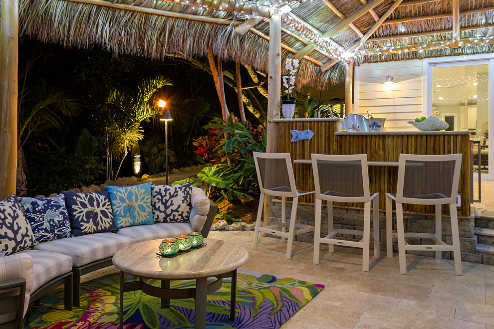 Photo of a mid-sized beach style backyard patio in Miami with an outdoor kitchen, natural stone pavers and a gazebo/cabana.