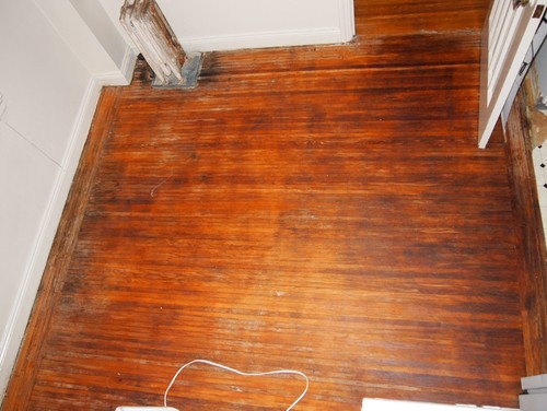 Discovering wood floors under linoleum. 1920's building.