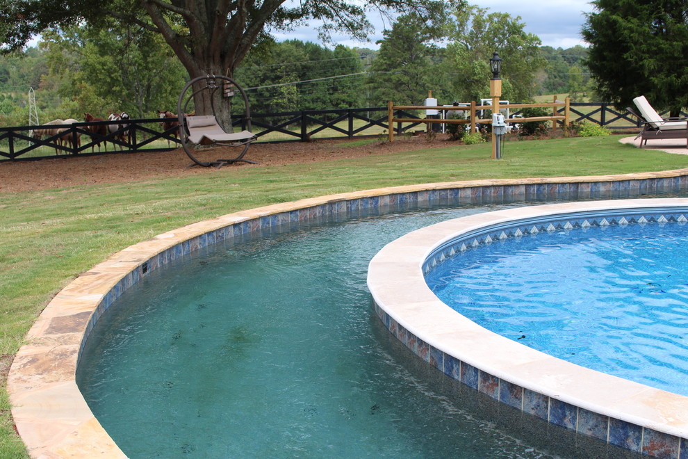 Design ideas for an expansive country backyard custom-shaped pool in Atlanta with a water feature.