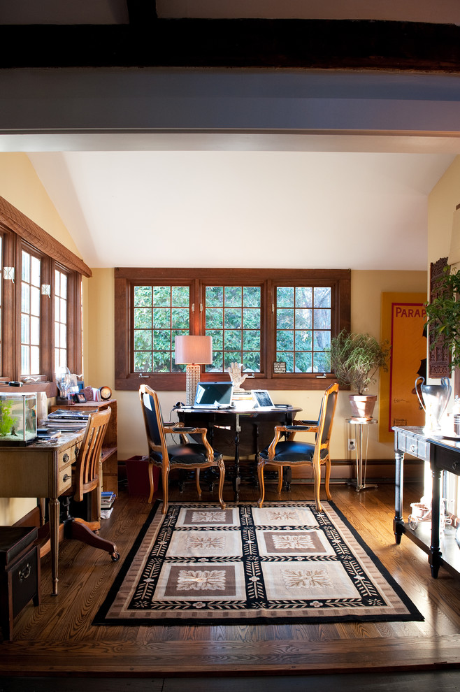 Country home office in Boston with beige walls and dark hardwood floors.