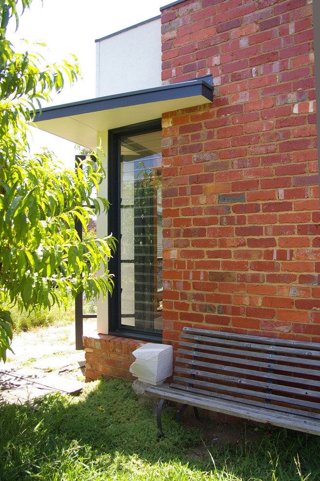 Inspiration for a small contemporary one-storey brick red exterior in Melbourne.