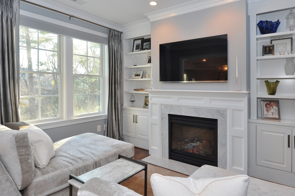 Inspiration for a traditional family room in DC Metro with grey walls, a standard fireplace and a stone fireplace surround.
