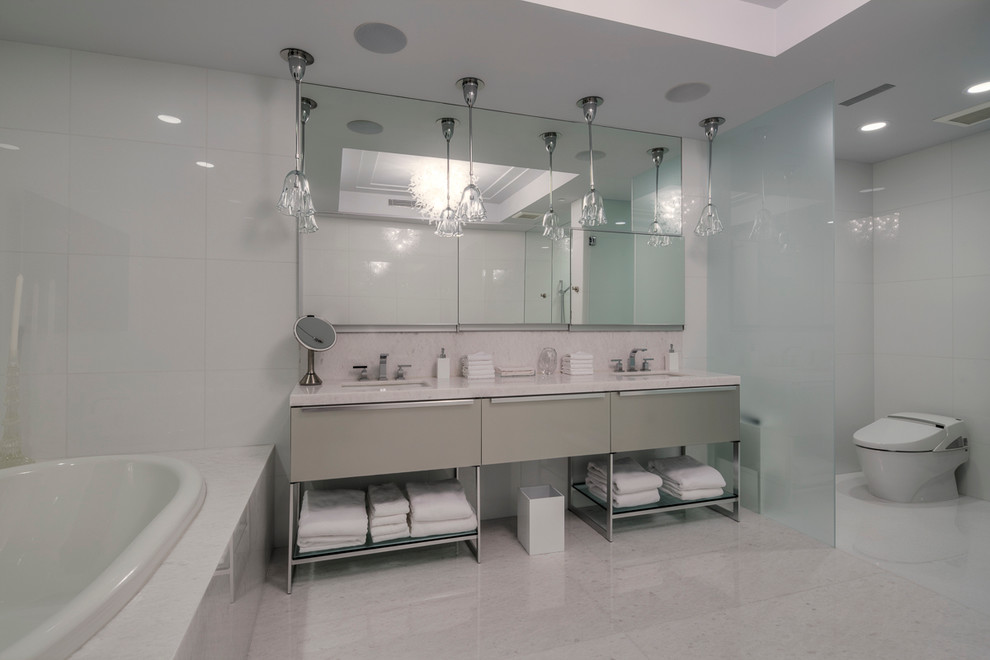Photo of a contemporary bathroom in Miami with white tile and marble floors.
