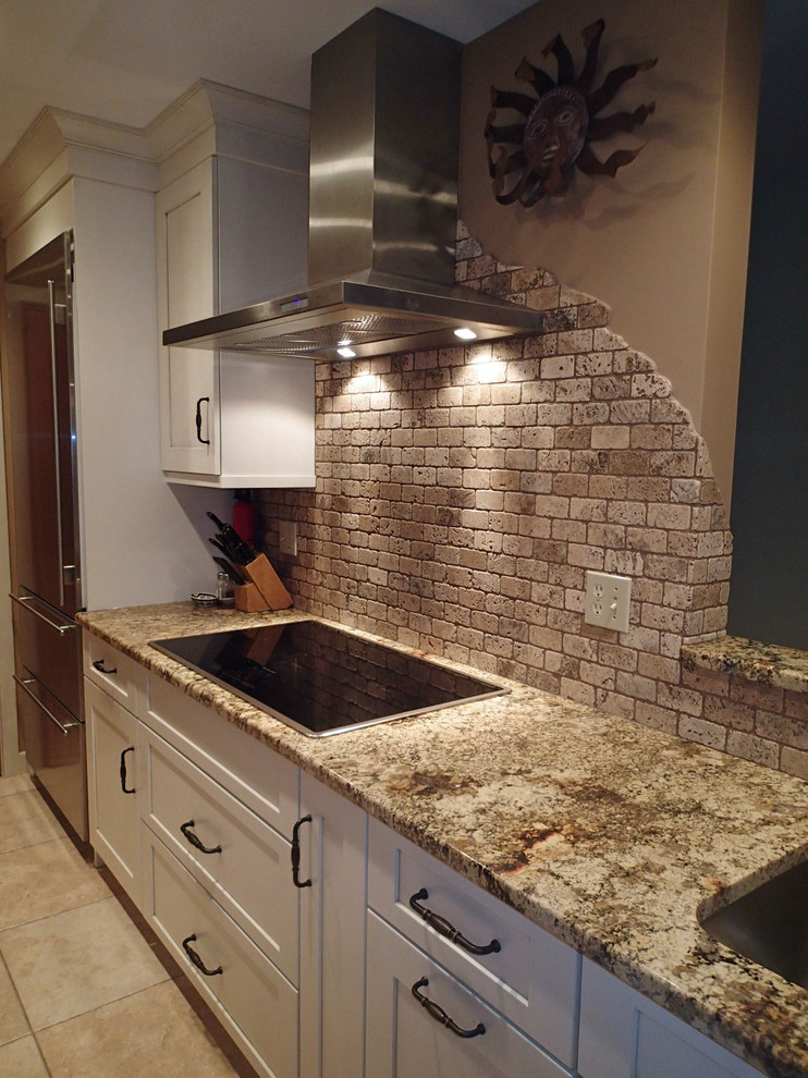 Large mountain style ceramic tile eat-in kitchen photo in Bridgeport with an undermount sink, shaker cabinets, granite countertops, beige backsplash, stone tile backsplash, stainless steel appliances and an island