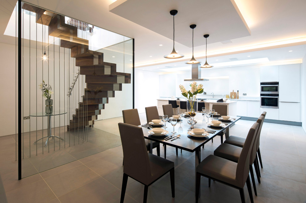 Photo of a large contemporary open plan dining in London with white walls, slate floors and grey floor.