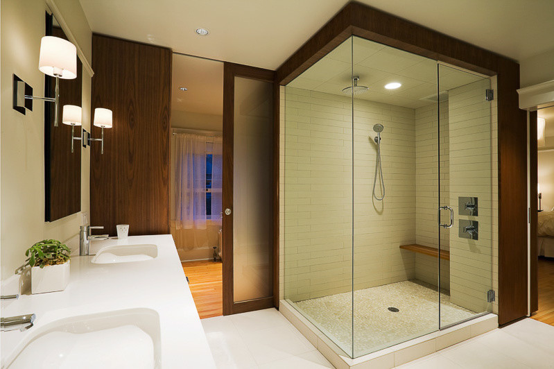 Example of a large transitional master white tile white floor corner shower design in Denver with flat-panel cabinets, white walls, an undermount sink and a hinged shower door