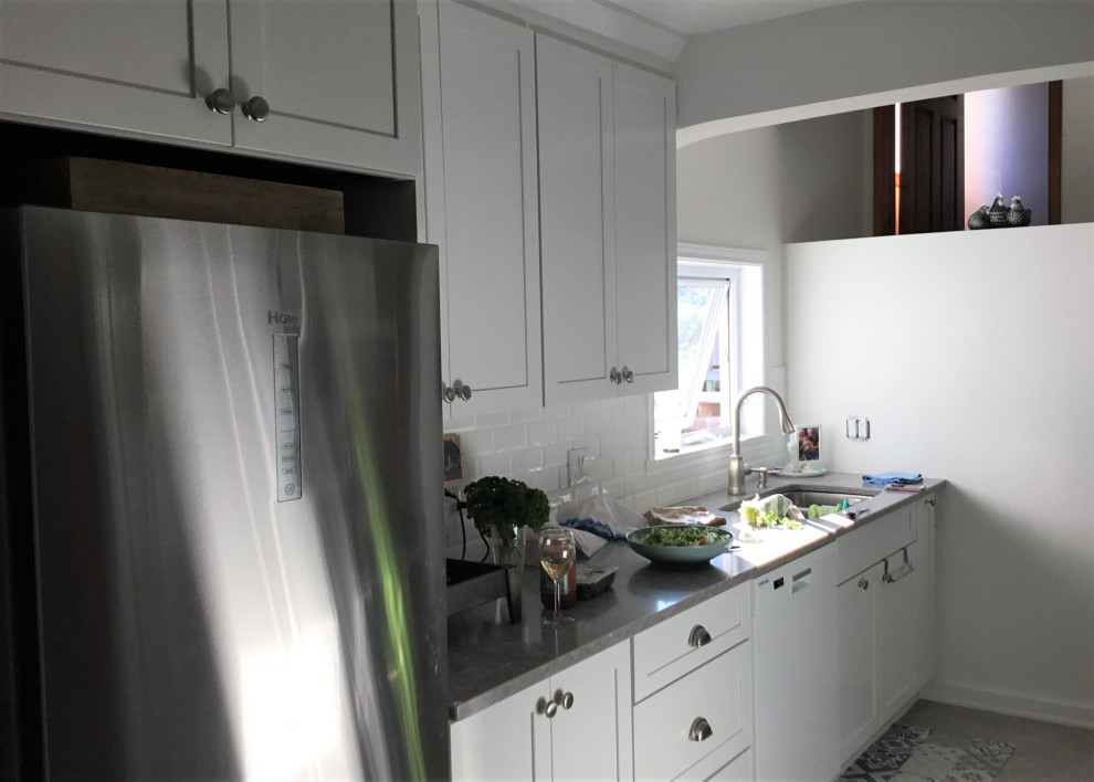 Inspiration for a mid-sized transitional galley ceramic tile and gray floor eat-in kitchen remodel with an undermount sink, shaker cabinets, white cabinets, quartz countertops, white backsplash, subway tile backsplash, stainless steel appliances, a peninsula and gray countertops