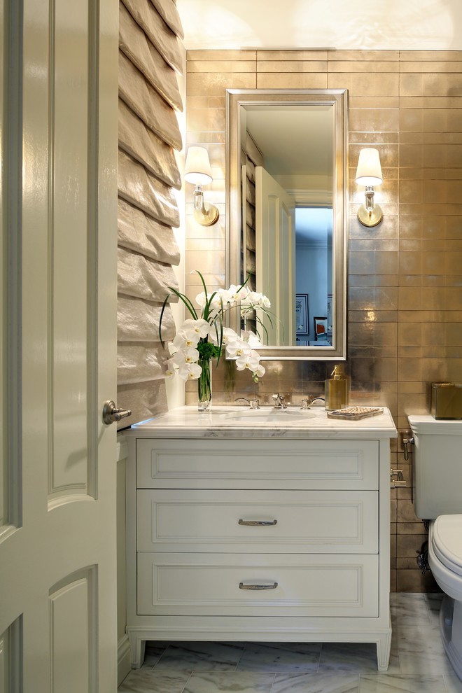 Mid-sized traditional 3/4 bathroom in Los Angeles with furniture-like cabinets, white cabinets, a two-piece toilet, multi-coloured tile, metal tile, multi-coloured walls, marble floors, an undermount sink, marble benchtops and white floor.
