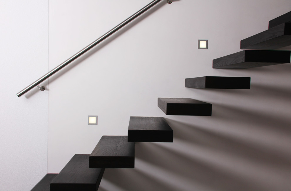 Inspiration for a contemporary wood floating staircase in Stuttgart with glass railing.
