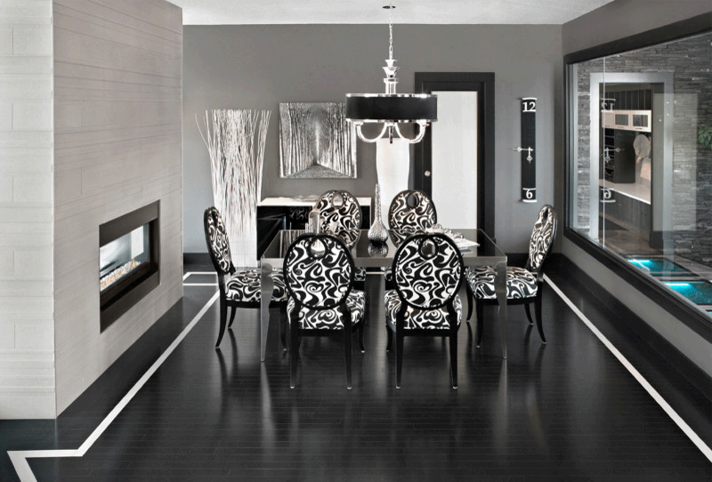 Photo of a large traditional separate dining room in Toronto with grey walls, dark hardwood floors, a two-sided fireplace, a tile fireplace surround and black floor.