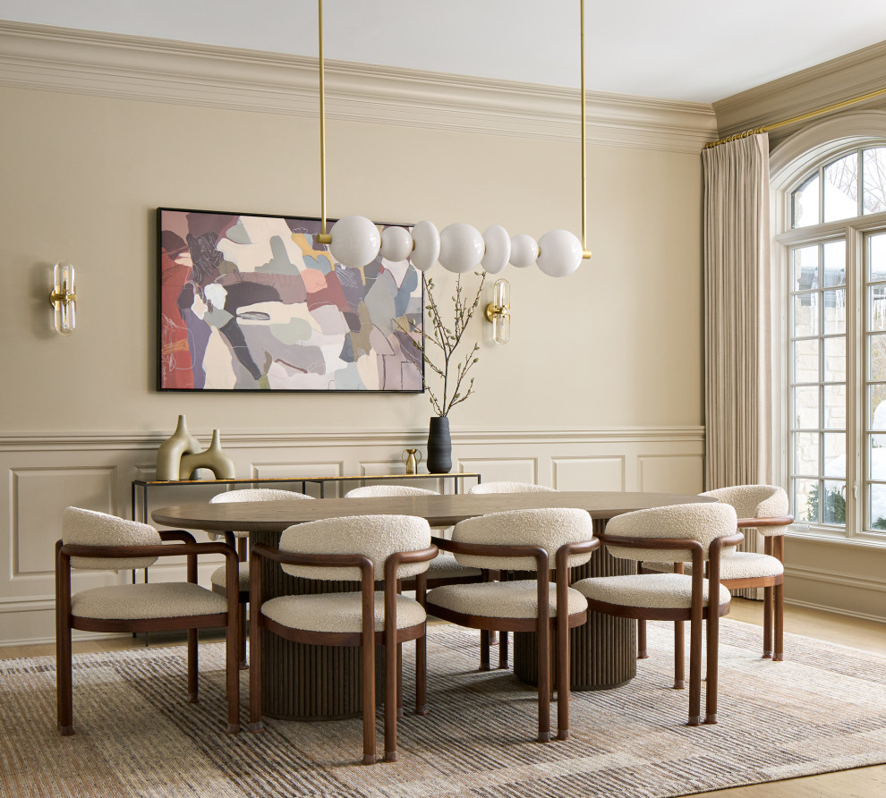 Inspiration for a large timeless light wood floor, brown floor and wainscoting enclosed dining room remodel in Chicago with beige walls