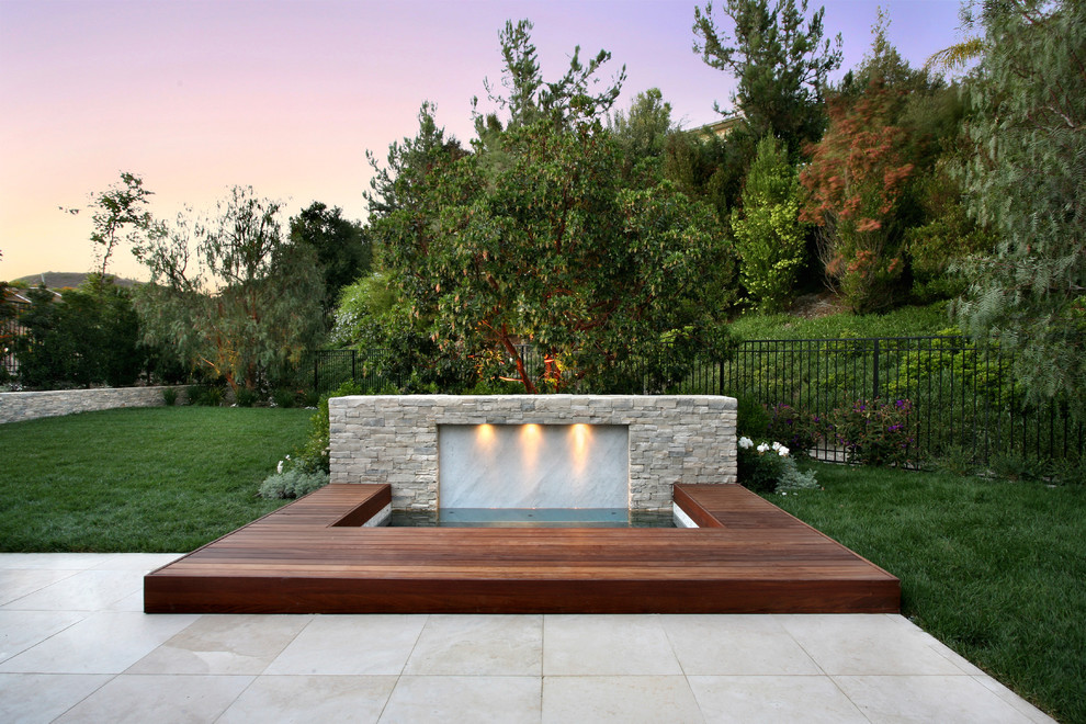 Design ideas for a contemporary garden in Orange County with a water feature and decking.