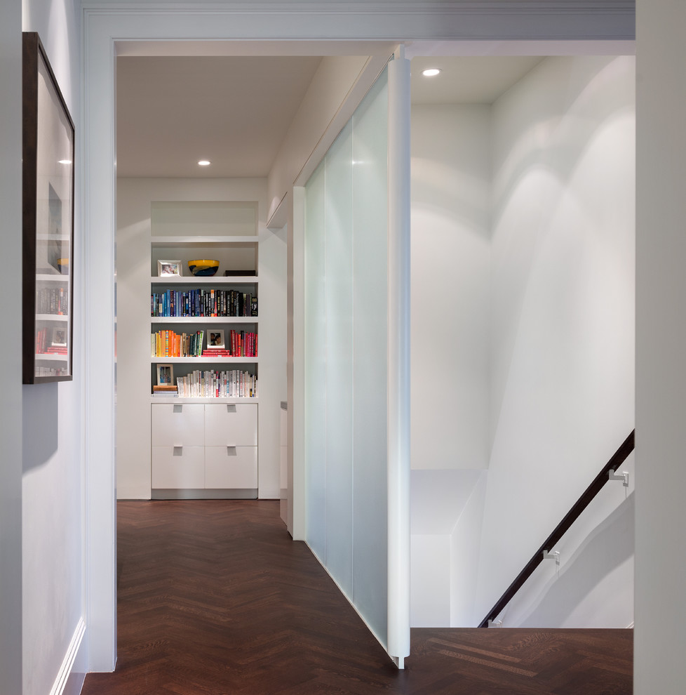 Inspiration for a contemporary hallway in San Francisco with white walls and dark hardwood floors.