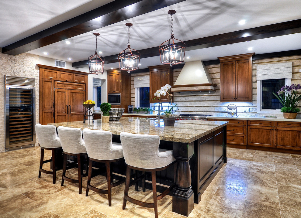 Mid-sized traditional u-shaped kitchen in Orange County with an undermount sink, recessed-panel cabinets, medium wood cabinets, stainless steel appliances, travertine floors, with island and brown floor.